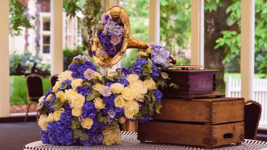 A record player with flowers spilling out of it