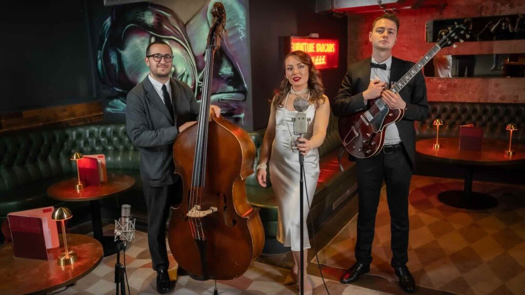 A trio of jazz performers posing for a group shot