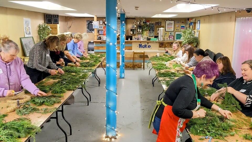 A woodland wreath making workshop showcasing how guests can get involved at conference events with the product and activities