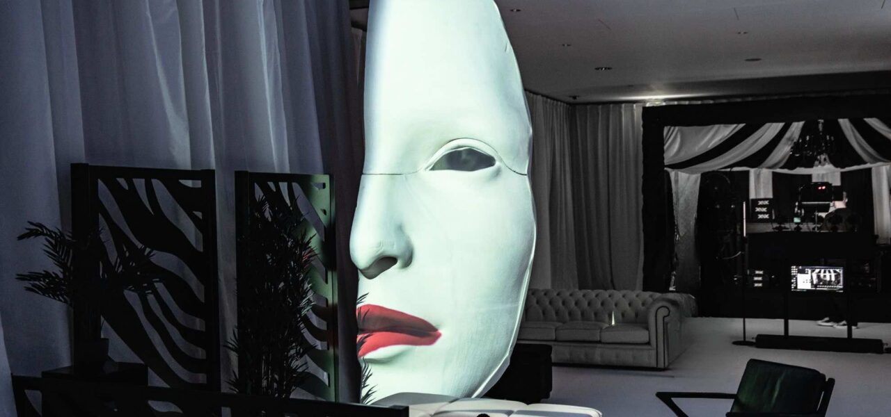 Black and white event theming featuring a glowing mask 3d projection prop curated for the Sidemen event.