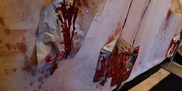 Bloodied hanging IV drips part of a chilling Asylum event theming.