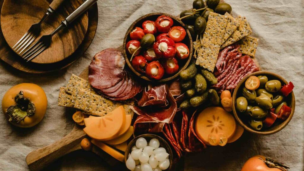 Rustic event catering board with cheeses, olives and more.