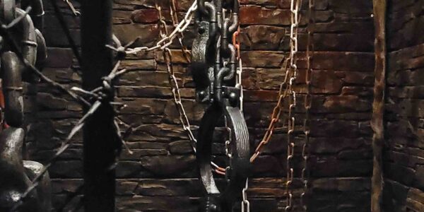Hanging chains and cuffs used for a set design prison at a Halloween event.