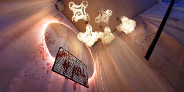 Hanging hospital patient sign covered in fake blood with the message HOSPITAL OF HELL greets nightclubbers at TABU nightclub Asylum themed event.