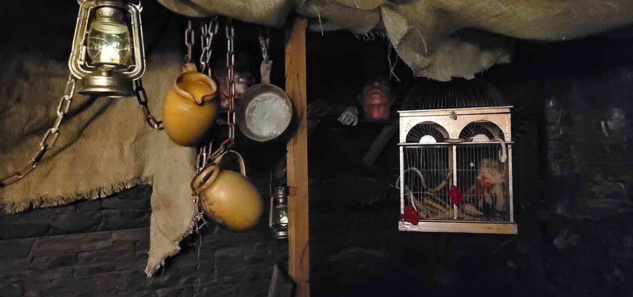 Ancient Egyptian event theming including hanging pots and pans with cage, part of a marketplace installation designed for an Egypt theme Halloween party.