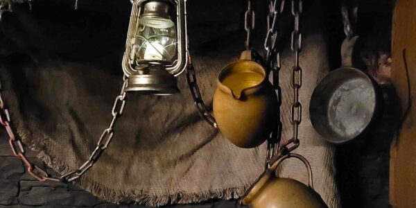 Hanging pots, pans and lanterns, props for Egyptian event theming as part of a marketplace installation.