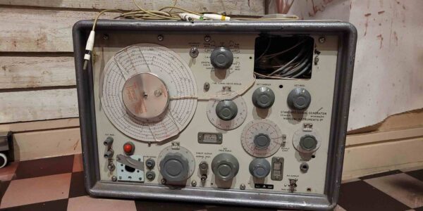 A vintage electroshock therapy machine prop adds a chilling touch to the Asylum-themed Halloween setup, evoking dark medical history.