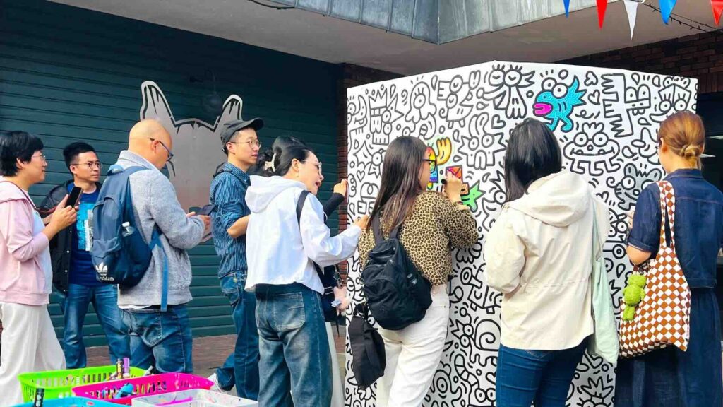 A live doodle mural wall with guests filling in the blanks