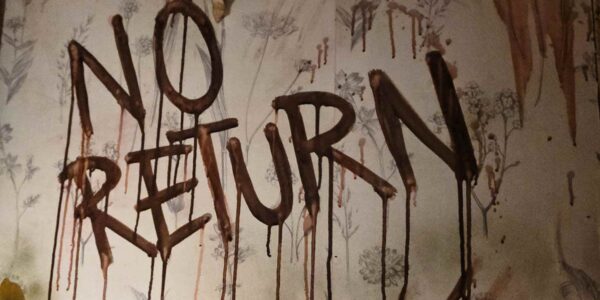 NO RETURN" is scrawled in blood across the decaying hospital wall, setting the stage for a nightmarish Asylum experience.