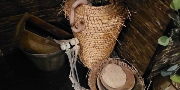 Egyptian themed props including rattan baskets and skeleton prop for Halloween.