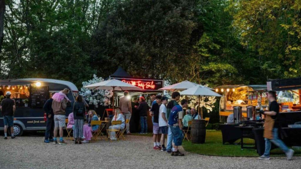 Festival style catering for outdoor summer event including food trucks and mobile vans.