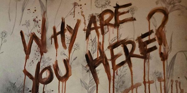 WHY ARE YOU HERE bloody sign written on the wall of a terrifying Asylum Halloween theme.
