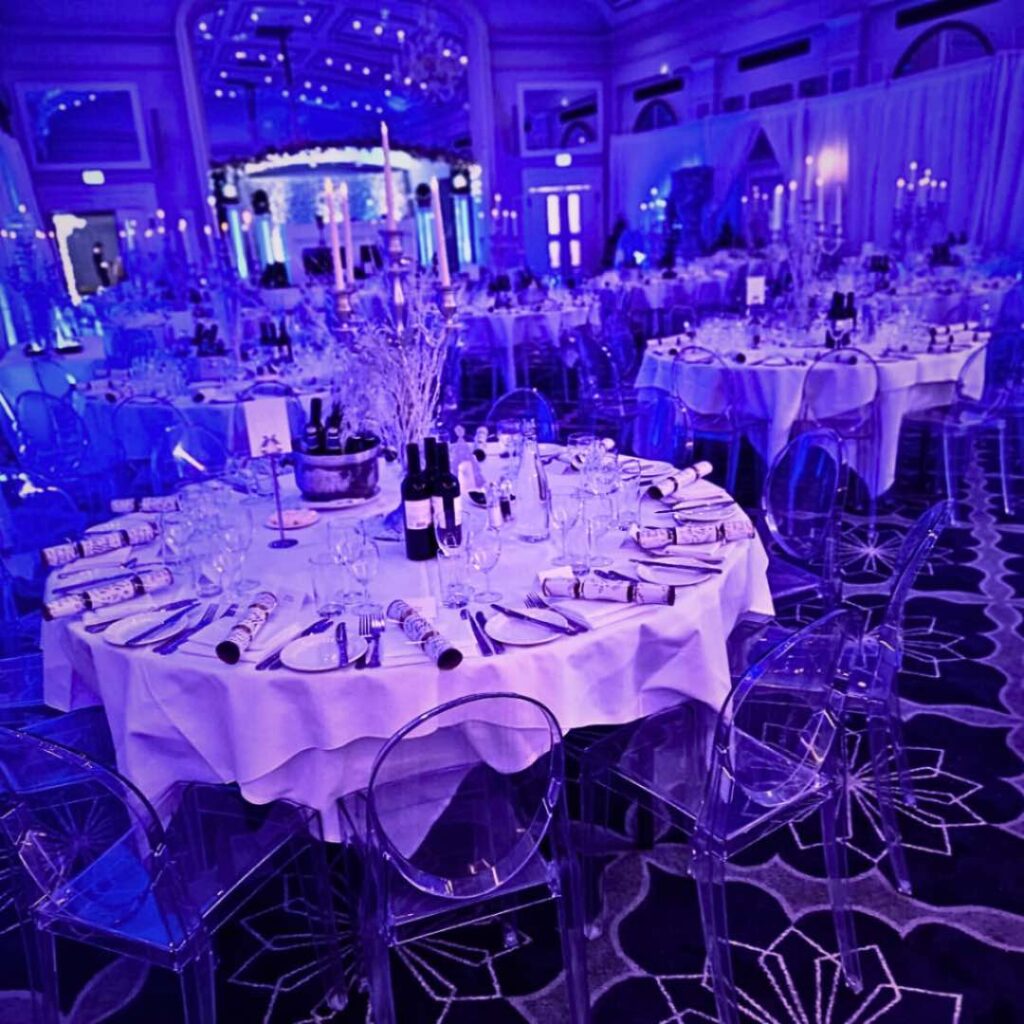 Winter Wonderland theming with clear chairs and stunning centrepieces as well as mirrored dance floor prop.