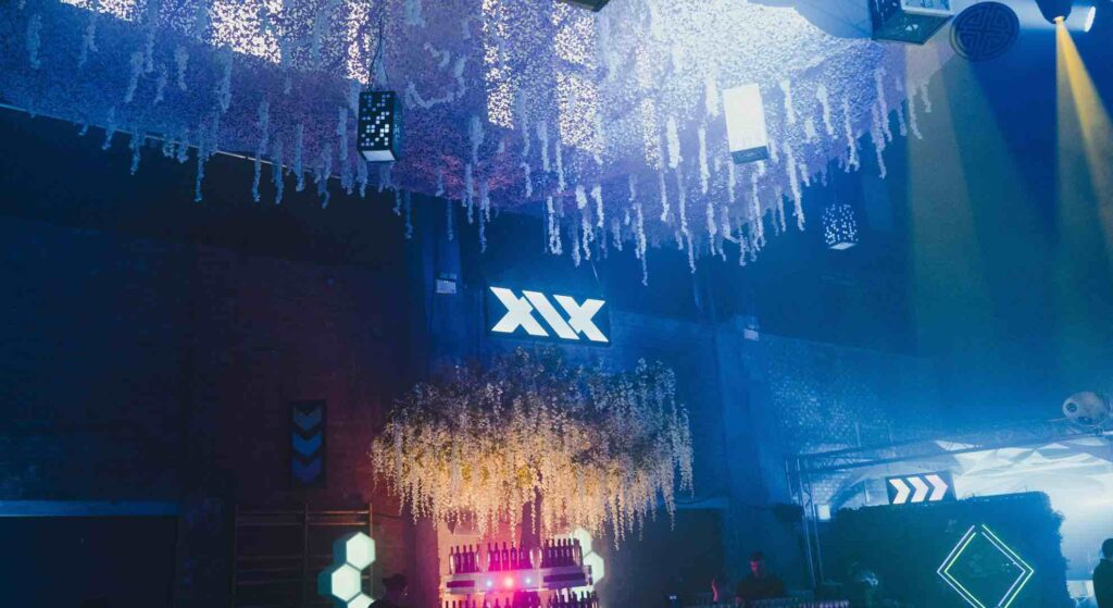 Tokyo event theming showcasing props and event decor transforming a venue for Sidemen Vodka Launch including hanging ornaments, glowing signs and foliage chandelier.