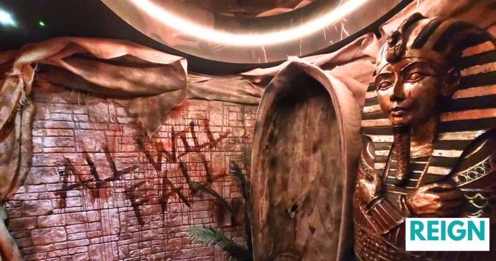 Reign nightclub Egyptian Halloween theming with 'ALL WILL FAIL' terrifyingly splattered in blood across the wall with Egyptian props and set design.