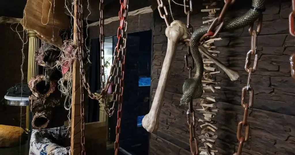 Hanging chains, bones and snakes used to decorate an immersive set design installation for Halloween.