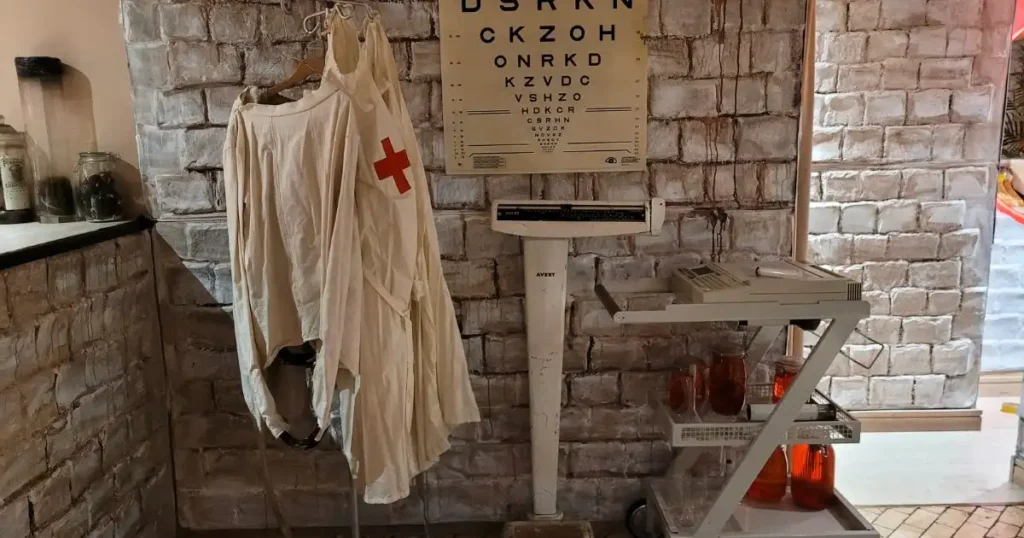 Halloween venue styling including vision sign, doctors coat and weighing scales used as part of Halloween set design. 