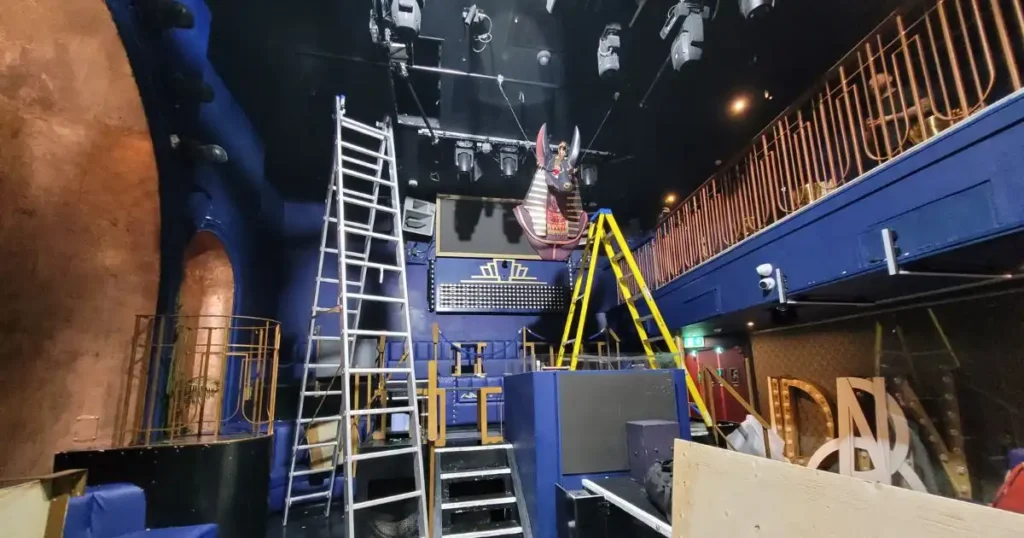 Event production team erecting a giant Anubis prop at REIGN nightclub.