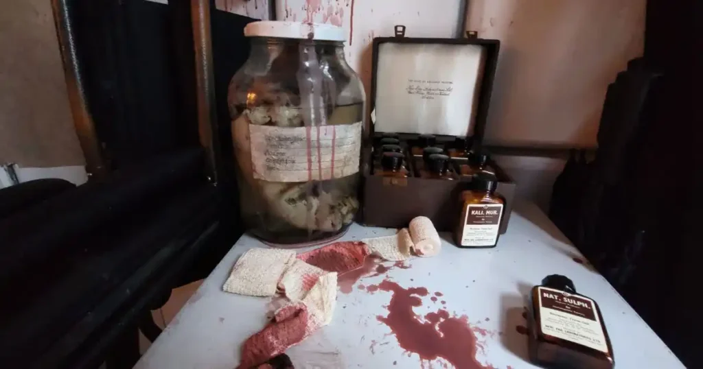 Mason jar and box splattered with blood used as props for a Halloween venue transformation in London. 