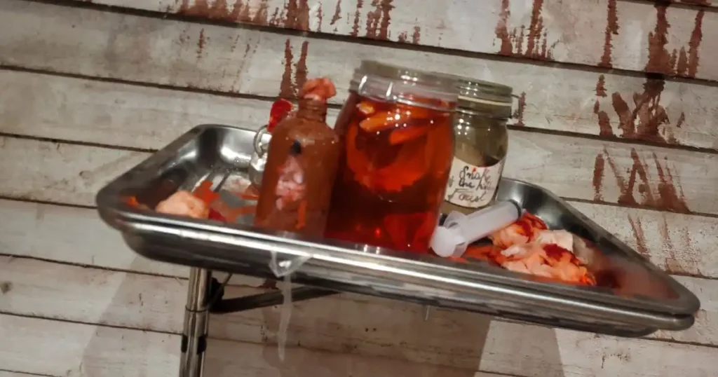 Gory hospital tray with Halloween event props put together as part of a Halloween event set design. 