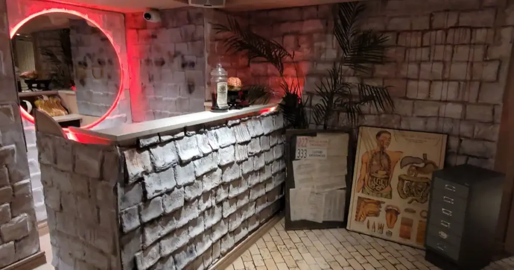 TABU nightclub bar area styled with various old hospital relics such as posters, jars and medical props to bring the Asylum theme to life. 