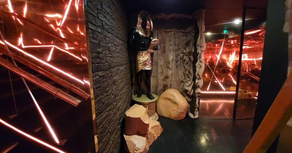 Egyptian statue prop used with venue theming to decorate the transition space between stairs at REIGN nightclub.