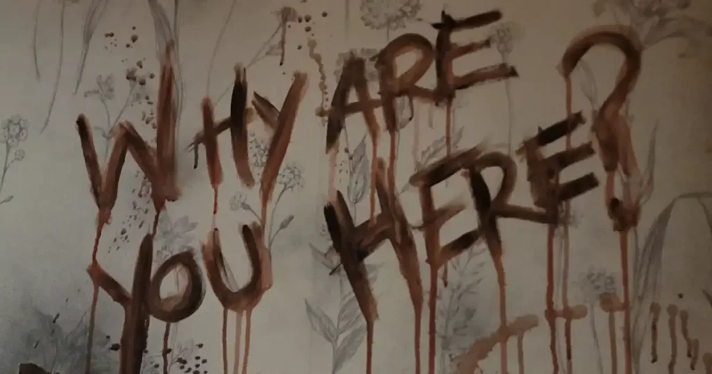 "Why are you here?" message written in terrifying blood smears as a visual effect for a bespoke Halloween theming. 