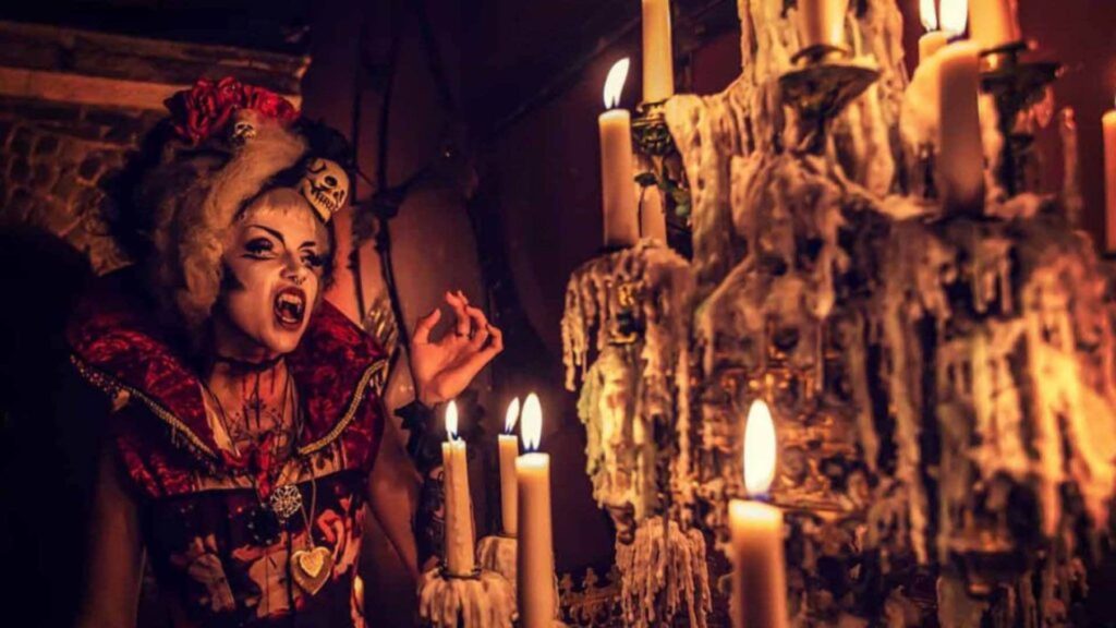 A gothic vampire themed Halloween event with candles and actors.