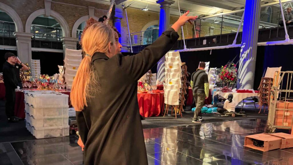 Julia Charles directing sound people at an event.