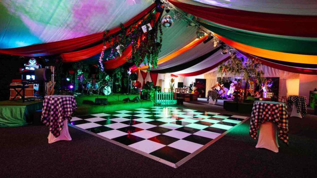 Subtle lighting around an Alice and Wonderland dancefloor at an event.