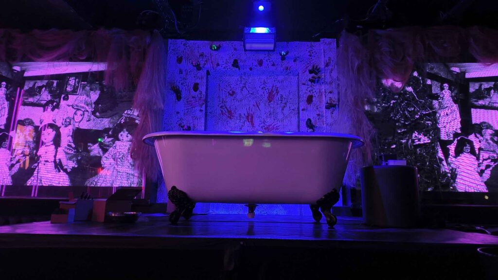 Bespoke Halloween stage design featuring a vintage bathtub, immersive scenic installation and theatrical lighting for a Halloween nightclub transformation.