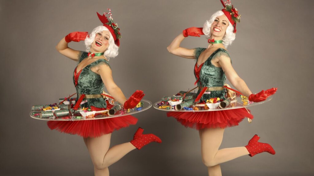 Two Christmas human tables posing for a photo.