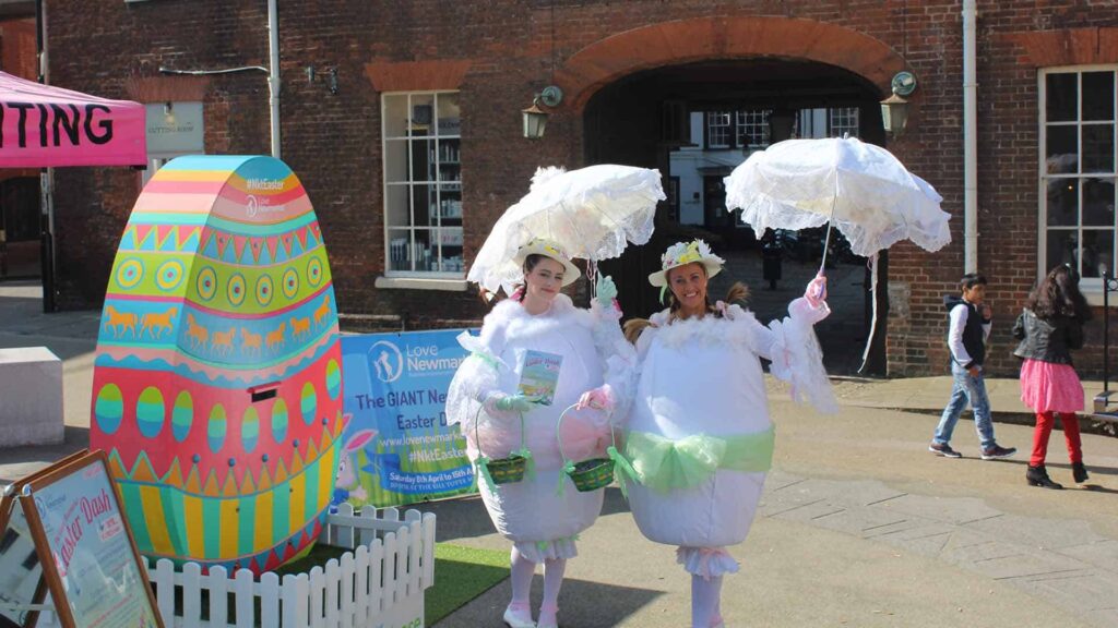Two easter egg performers at an outdoor market event