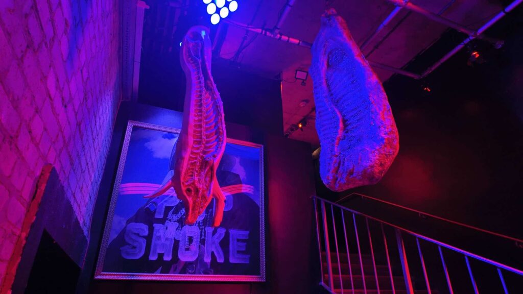 Hanging animal props suspended from the ceiling as part of an immersive Halloween nightclub transformation with professional scenic installation and atmospheric lighting.