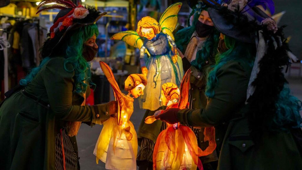 Illuminate fairy puppets at a Christmas event.