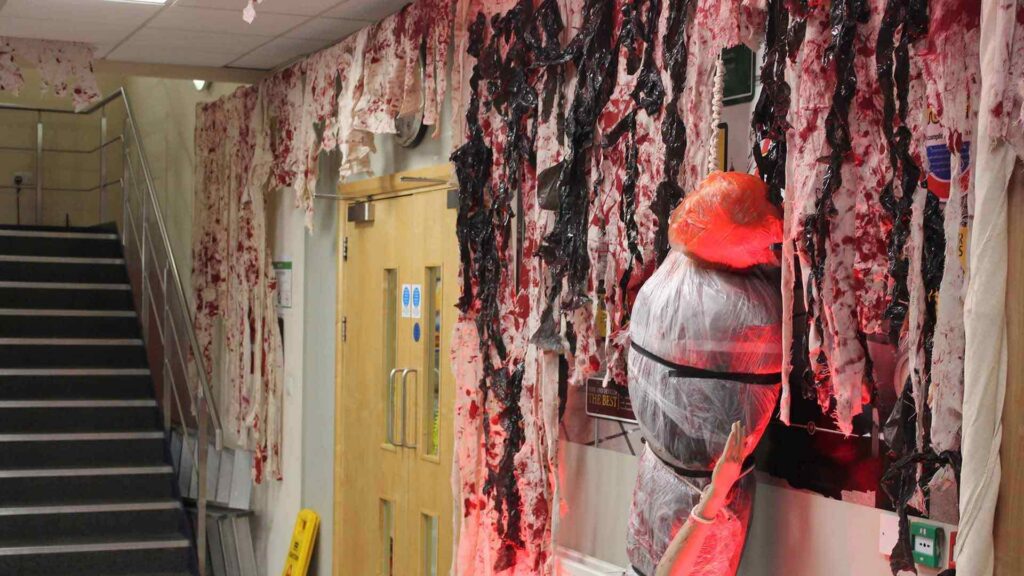 An immersive office space with bloody wall draping.