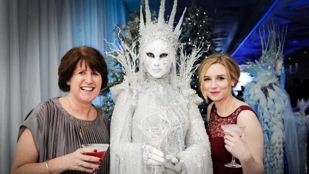 An ice queen performer meeting guests at an event.