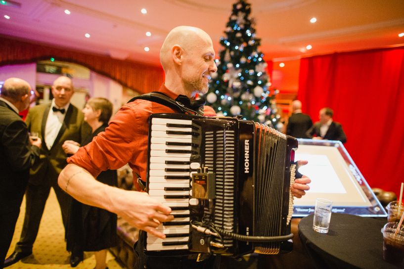 A Renault F1 Christmas party performer playing music.