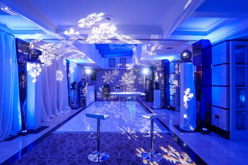 A unique winter wonderland themed dancefloor with blue lighting and snowflakes.