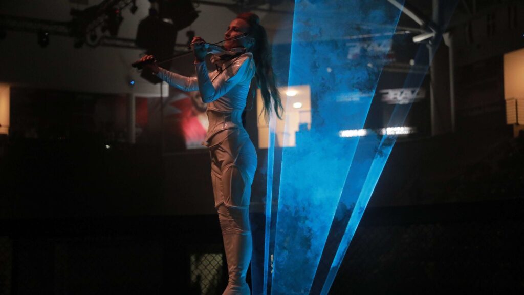 Stunning violin led performances featuring futuristic costumes and laser lights at a Christmas event.