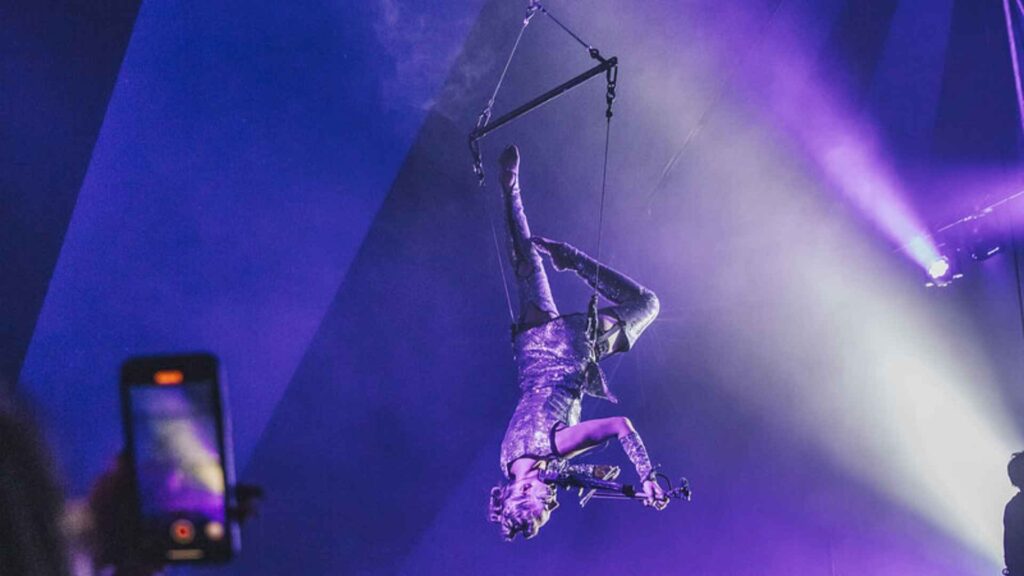 A mesmerising aerial violinist dangling from her foot above crowds.