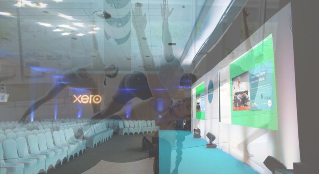 Team building yoga session overlaying conference event space.