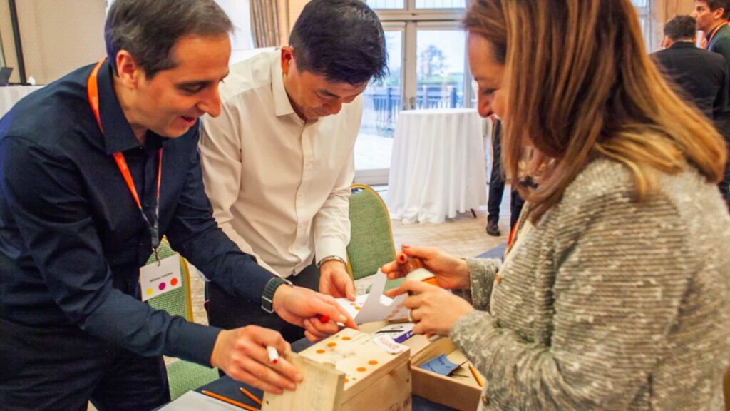 A group participating in a green team building activity for sales events.