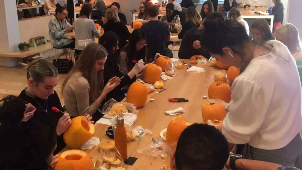 Colleagues taking part in a pumpkin carving workshop.