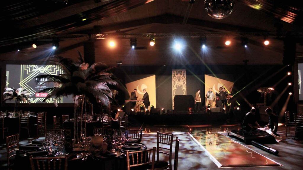 A bond inspired gala dinner space with gold and black theming in a classic Bond colour palette.