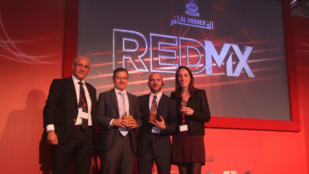 A team of 4 on stage at a sales kick off event. 