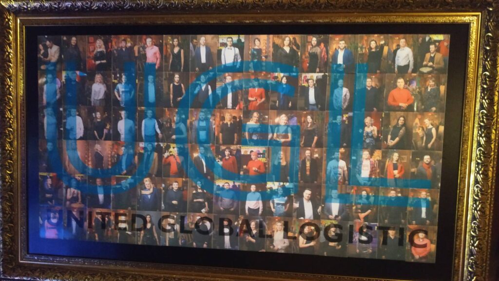 Finished photo mosaic wall featuring company branding and guest portraits.