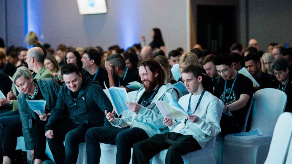 Teams aligning at a revenue kick off event with agendas in hand.