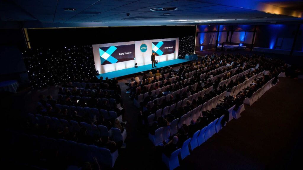 Speaker on stage at XERO conference event managed by conference organisers Julia Charles Event Management.