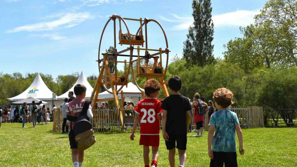 Children enjoying a human-powered wooden wheel ride for events.